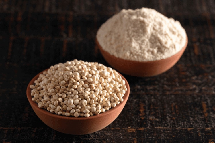 A Bowl of Sprouted Sorghum and Sorghum Flour on a Dark Wooden Table