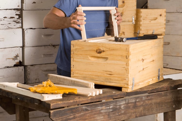 Close-up of man building beehives