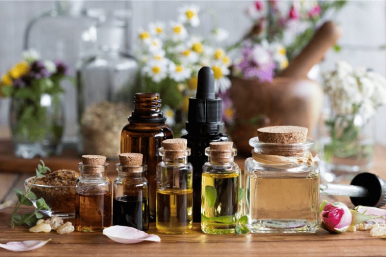 Bottles and droppers of essential oils from various herbs and flowers